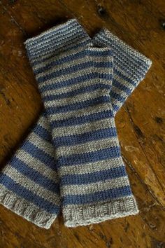 a pair of blue and white knitted gloves