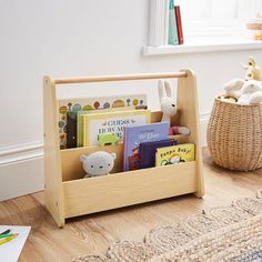 a child's book shelf with books and stuffed animals