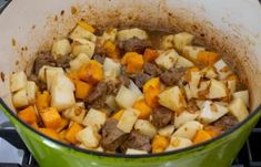 a pot filled with food sitting on top of a stove