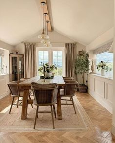 a dining room with wooden floors and white walls