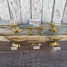 four brass skateboards with names on them