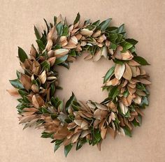 a wreath made out of green leaves on a brown background with space for the letter o