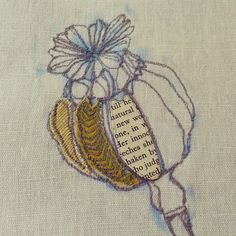 a close up of a piece of cloth with embroidery on it and a flower in the middle