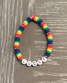 ☘️🌈☘️🌈 Get ready for St Patrick's Day with this cute rainbow and gold LUCKY bead bracelet! 🌈☘️🌈☘️ Can also be customized with your own word or name of your choice.  ☘️ Colored beads are 6 mm heishi beads 🌈The gold discs are 14k gold plated beads  ☘️Letters are all capitalized, letter beads are white with gold   🌈 Bracelets are tied with a secure knot  ☘️Strong elastic band is used in white  🌈🌈IMPORTANT- Measure your wrist prior to ordering with a flexible measuring tape or measure with a string and then measure string with ruler or tape measure. As I do not accept returns or exchanges. If your size is not listed please tell me your size in the personalization section of your order. ⭐️⭐️ 🌈To order select your size in the drop down menu.  ☘️If you would like to change the word LUCKY Hypoallergenic Rainbow Bracelets With Round Beads, Hypoallergenic Rainbow Beaded Bracelets, Rainbow Heishi Beads Friendship Bracelet, Rainbow Jewelry With Letter Beads For Gift, Rainbow Heishi Beads Bracelets As Gift, Rainbow Colored Jewelry With Letter Beads For Gift, Rainbow Heishi Beads Beaded Bracelets As Gift, Rainbow Heishi Beads Bracelet As Gift, Everyday Rainbow Bracelets With Letter Beads