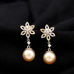 Product Details This Floral Pearl Drop Earrings embellished with Round Shape South Sea Pearl and small Round Shape Diamonds are set on the half flower in a Pave Setting, crafted in a Solid Gold. Product Information SKU SHP-EARRINGS122045753 Weight 2.24 gm (Approximate) SOUTH SEA PEARL INFORMATION No.of Stones 2 Pieces Total Weight 11.36 Carat (Approximate) Dimension(approx) Round-9X9 mm-2 Pcs Color Golden Cut Brilliant Shape Round Setting Type Bead-Set Quality Grade AAA DIAMOND INFORMATION No.of Half Flower, Sea Pearl, Signature Jewelry, Pave Setting, South Seas, South Sea Pearls, Sea Pearls, Timeless Jewelry, Floral Earrings