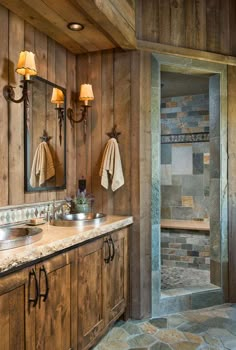 a bathroom with wood walls and stone flooring