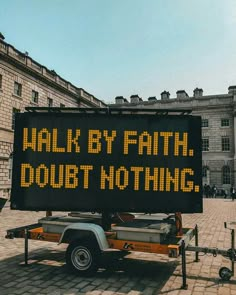 a sign that says walk by faith, doubt nothing on the back of a truck