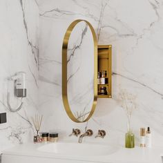 a bathroom with marble walls and gold accents