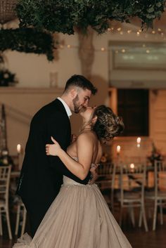 a bride and groom sharing a kiss at their wedding reception