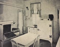 an old black and white photo of a kitchen with refrigerator, stove, table and chairs