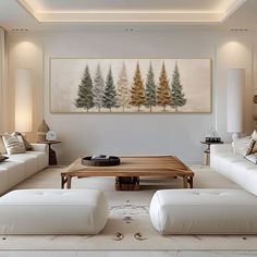 a living room filled with white couches and a coffee table in front of a painting