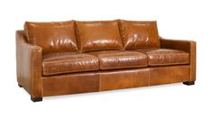 a brown leather couch sitting on top of a white floor