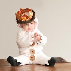 a baby in a bunny costume sitting on the floor