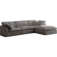 a gray sectional couch with pillows on it's back and the seat folded out