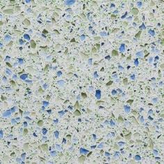 an image of water drops on the surface of a window pane with blue and green speckles