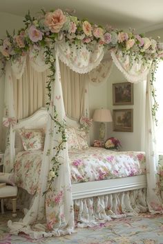 a canopy bed with pink flowers on it