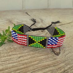 Friendly beaded bracelet with Jamaica and USA flags. Loom hand woven wristbandt is a great gift for a men, women, or child for American Independence Day, Birthday, Christmas, Valentine's Day and other holidays.  Is suitable for daily wear. Bracelet in stock and ready to ship. -------------------------------------------------- More bracelets with flags here: https://www.etsy.com/shop/BeadSeeShop?ref=seller-platform-mcnav&section_id=36120104 ------------------------------------------------ The bra Multicolor Resizable Beaded Bracelet As Gift, Multicolor Resizable Beaded Bracelet For Gift, Multicolor Resizable Beaded Bracelet Gift, Resizable Multicolor Beaded Bracelet Gift, Black Handwoven Friendship Bracelets As A Gift, Multicolor Beaded Friendship Bracelets As Gift, Multicolor Beaded Friendship Bracelets For Gift, Casual Handwoven Beaded Bracelets As Gift, Casual Handwoven Bracelets For Gifts