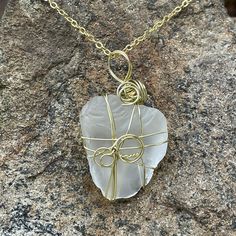 Wire wrapped, by hand, sea glass pendant.  Each pendant is unique in shape and design.  Wire is 22G Gold Aluminum.  Chain is 18" gold plated iron clad brass.  Please ask any questions! Gold Necklace With Recycled Glass For Gifting, Gold Necklace With Recycled Glass For Gifts, Gold Wire Wrapped Glass Necklaces, Gold Sea Glass Wire Wrapped Jewelry, Gold Wire Wrapped Sea Glass Jewelry, Green Sea Glass Wire Wrapped Jewelry, Spiritual Glass Necklace With Wire Wrapped Detail, Wire Wrapped Silver Necklace With Sea Glass, Wire Wrapped Sea Glass Pendant