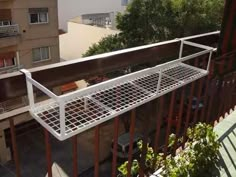 the balcony railings are attached to the building's balconies, which also have plants growing on them