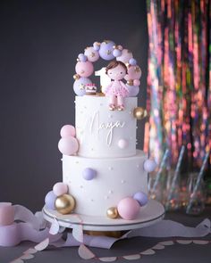 a white cake with pink and purple decorations