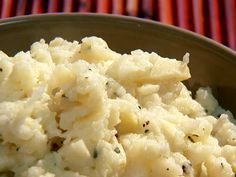 a bowl filled with mashed potatoes on top of a table