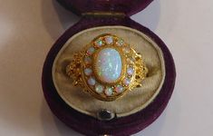 A fine silver 18ct gold plated cultured opal ring. the front oval panel is set with a large oval cutured opal surrounded by 14 smaller round cut opals all set in a solid silver and 18ct gold frame , the side shank of the ring is beautifully raised embossed with a three flower design. looks stunning when worn, ring size uk-p ,usa-7.75. box for display only will come boxed. Antique Style Opal Ring For Formal Occasions, Victorian Style Opal Ring For Formal Occasions, Antique Oval Opal Ring, Victorian Style Oval Opal Ring With Hallmark, Victorian White Oval Opal Ring, White Oval Victorian Opal Ring, Victorian Style Oval Opal Ring Hallmarked, Victorian Oval Opal Ring Hallmarked, Luxury Victorian Opal Gemstone Ring