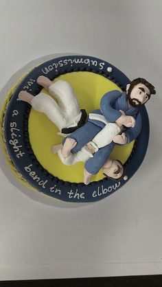 there is a cake with two people on it