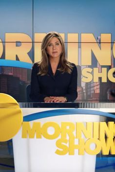 a news anchor is sitting in front of the morning show sign with her hand on her hip