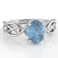 Celtic trinity motif diamond curles ring with an oval shape blue topaz center stone crafted in solid 14k white gold. Blue topaz is the birthstone of December and is known for providing strength and clarity. Diamonds are thought to provide the wearer with better relationships and increase inner strength. Genuine Blue Topaz: Qty: 1 x 5x7 Oval Cut Stone Genuine Diamonds: .05 caratsQty: 2 x 1.3mm Round H|IQty: 2 x 1.6mm Round H|IAll of our products are available in 925 Sterling Silver, Solid 10k/14k Plain Gold Ring, Love Ring, Inner Strength, Men's Rings, Earrings Collection, White Rose Gold, Celtic Knot, White Topaz, Pendant Earrings