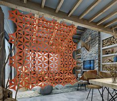 a living room filled with furniture and walls covered in orange geometric design panels on the wall