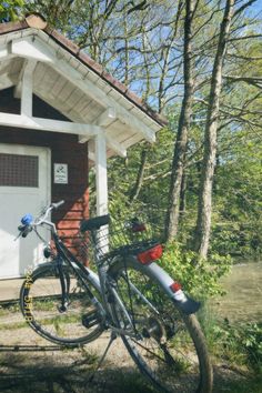 two bikes parked in front of a small building