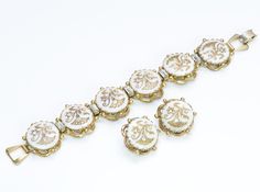 Kramer New York Bracelet Earrings Set. Rare 1950’s Kramer of NY bracelet and earrings set. Gold tone white/gold Victorian style. Approximate Measurements: Bracelet: Length 7.5”, Width 1” Earrings: Diameter 1” Made in: USA Condition: Very Good Antique White Bracelet Jewelry, White Costume Jewelry For Formal Occasions, Classic White Evening Bracelets, White Costume Jewelry Earrings For Formal Occasions, White Costume Jewelry Earrings For Formal Events, White Antique Bracelet Jewelry, Victorian White Jewelry For Evening, White Antique Jewelry For Formal Occasions, White Antique Bracelet