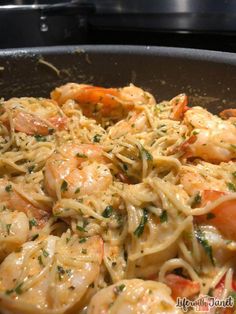 pasta with shrimp and parmesan cheese in a skillet