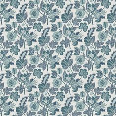 a blue and white floral wallpaper with many different flowers on the side, including green leaves