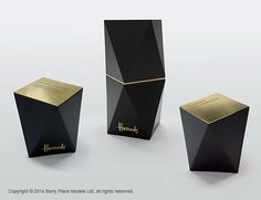 three black boxes with gold trim on the sides and one has a name on it