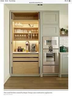 an open cabinet in the middle of a kitchen