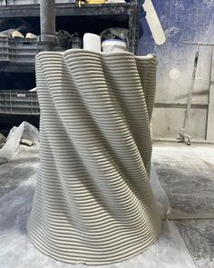 a large white vase sitting on top of a table