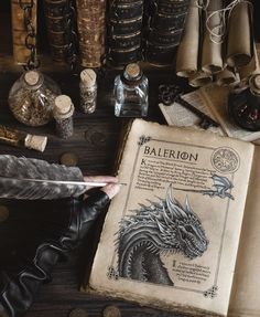 an old book sitting on top of a wooden table next to bottles and other items