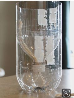 a clear glass container sitting on top of a table next to a pair of scissors