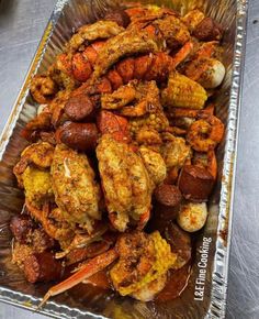 shrimp and corn on the cob in a glass dish