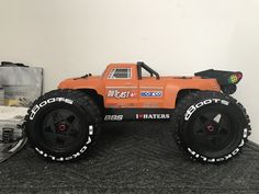 an orange toy truck sitting on top of a table