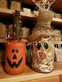 two mason jars decorated with halloween decorations