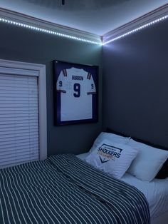 a bedroom with a football jersey on the wall