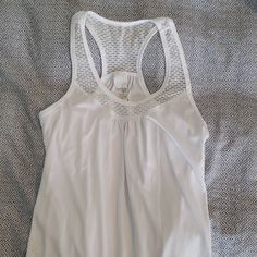 Very Cute All White Danskin Tank Top W Mesh Looking Material Around Neck Area, With Drawstrings Bottom. Never Worn But Has Small Spot I'm Sure Will Wash Out. Last Pic Show Small Spot. White Summer Tank Top For Workout, White Summer Workout Tank Top, White Summer Workout Top, White Stretch Summer Top, White Tank Top, White Tank, All White, Gray White, Tank Top