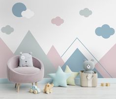 a child's room decorated in pastel colors with mountains and clouds painted on the wall