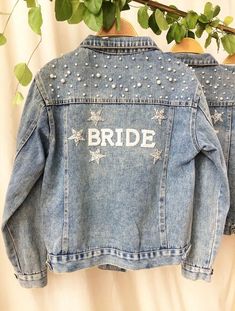 Shop our gorgeous collection of Bride wifey Blue Denim jackets  Blue Denim Bride to be Mrs personalised custom Bride Denim jacket wifey honeymoon wedding jacket Bridal engagement gift for her  ♡ Full length  ♡ long sleeved  ♡ true to size lose fit  ♡ Bride / wifey Sizes  Please see the measurements  Chart for sizes  Options will be available in the drop down menu  ♡ Name on the back    OUR POLICY  We do not except returns or exchanges on our custom made orders please make sure you have the corre Customizable Long Sleeve Denim Jacket, Customizable Denim Jacket, Jean Jacket Wedding, Jacket With Stars, Bride Jean Jacket, Bride Workout, Jeans Wedding, Wedding Coat, Embellished Denim Jacket