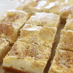 slices of cake sitting on top of a piece of parchment paper covered in powdered sugar