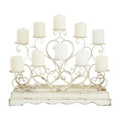 a white candle holder with many candles on it