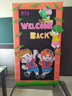 a welcome back sign with two children on it in front of a blackboard that says mt's welcome back