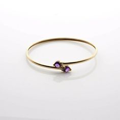 "10K Yellow Gold Amethyst and Diamond Accent Flexible Open BB, U Tube body, 2 6x6mm amethyst heart, 2 diamond accents, 2.25\"x1 7/8\"x1/8\", Circa 1990, 3.6 grams Stock # BB210B14 This listing contains photographs of the actual item you will receive. Our items are in excellent condition with little or no signs of wear and many are one of a kind pre-owned estate finds. Please look closely at the pictures in this listing as they are part of the product description. Please read the description, as Yellow Gold Amethyst Gemstone Bracelets, Yellow Gold Amethyst Bracelets With Gemstone, Yellow Gold Bracelets With Amethyst Gemstone, Amethyst Yellow Gold Bracelets With Gemstones, Amethyst Bracelet In Fine Jewelry Style, Amethyst Bangle Bracelets For Anniversary, Yellow Gold Amethyst Bracelet, Amethyst Bracelet Fine Jewelry, Open Bangle Bracelet